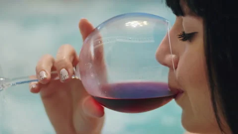 Close up With a stunning vine-covered background, a young woman enjoys her Stock Footage 237141114