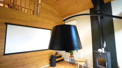 Close-up of a stylish hanging black modern lamp in a room with wooden walls Stock Footage 280010961