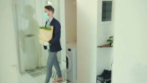 Close up stylish man coming back home after food shopping entering house taking Stock Footage 132541469