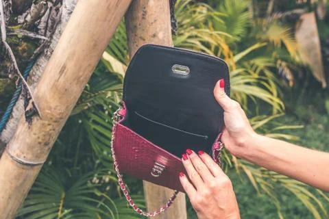 Close up of stylish snakeskin luxury python handbag on a tropical background. 写真素材