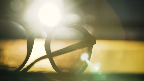 Close up of stylish sun glasses in sunset with a lens flare Stock Footage 102728294