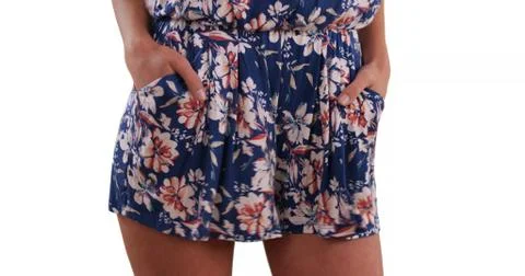 Close-up of stylish womans hands in romper pockets on solid white background Foto stock