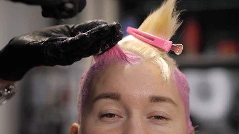 Close-up of stylist hands using professional hairbrush and dyeing hair roots Stock Footage 125547468