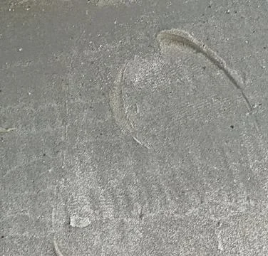 Close-up of subtle footprints in a layer of dust. This image provides a textu Stock Photos