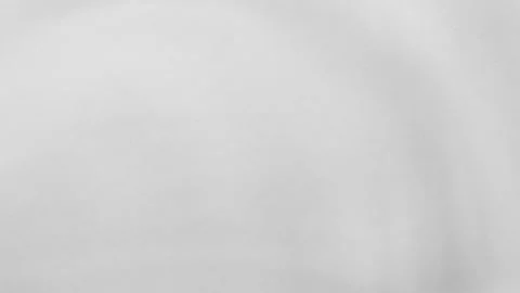 Close-up of a subtle water distortion pushing up a soft surface. Monochromatic Stock Footage 317919744