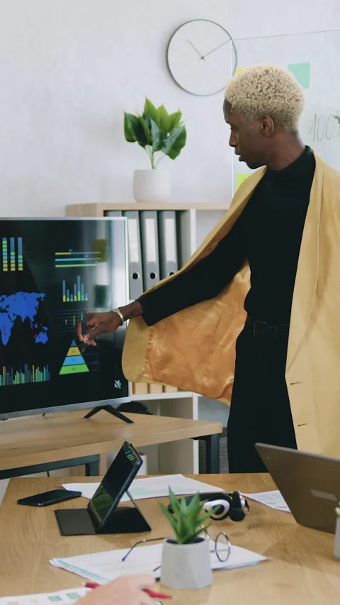 Close up of successful african man talking and showing sheet of paper with graph Stock Footage 334188189