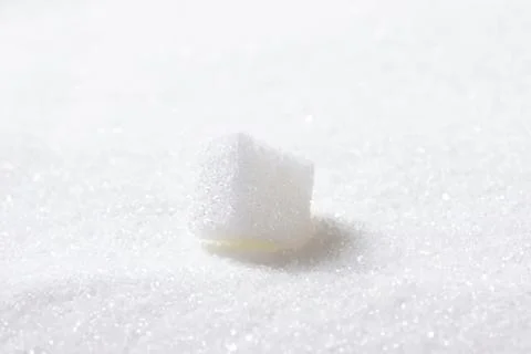 Close-up of sugar cube on white powder Fotos Stock