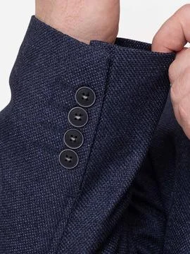 Close up of suit jacket cuff buttons with hand Foto stock