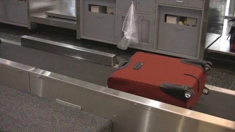 Close of a suitcase on conveyor belt. Stock Footage 79163113
