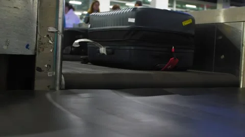 Close up of suitcases being moved by a baggage conveyor at an airport, 4k Stock-Footage 346704592