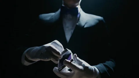Close-up of a Suited Magician's Hands Performing Sleight of Hand Card Tricks Stock Footage 129358975
