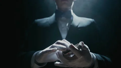 Close-up of a Suited Magician's Hands Performing Sleight of Hand Card Tricks 库存影片 180379747