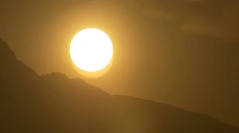 Close Up Sun disapearing behind mountain Rise Sunset Time Lapse timelapse 4k Stock Footage 67204739
