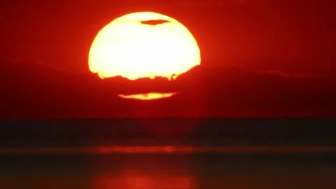 Close-up Sun Goes Down Behind The Clouds At Sunset In The Sea. Birds Fly By Stock Footage 166921882