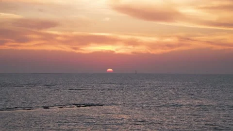 Close up of the sun over the sea at sunset in Cadiz Andalucia Stock Footage 232303641