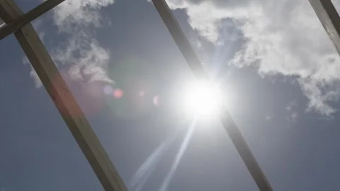 Close up sun shining through roofing beams Stock Footage 340820464