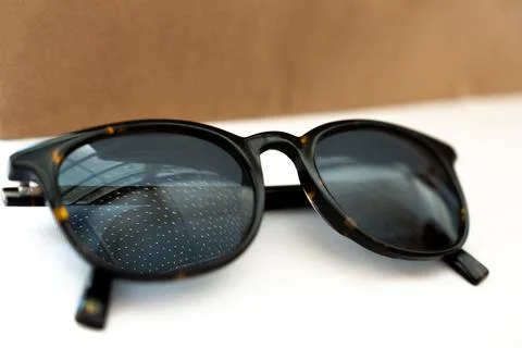 Close up of sunglasses with reflection of glowing dots. Glasses Stock Photos