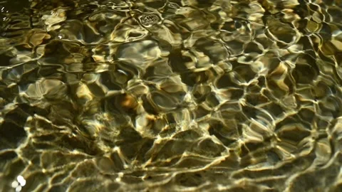 Close up of sunlight effects of the water in a mountain riverbed (slow motion) Stock Footage 211746070