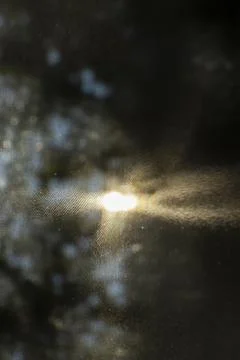 Close-up of sunlight filtering through a screen, creating a soft, hazy effect. Stock Photos