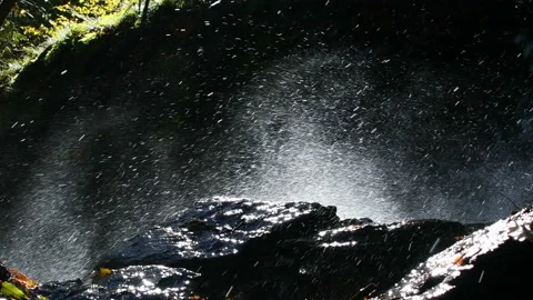 Close up of sunlit splashes of waterfall water Stock-Footage 142598905