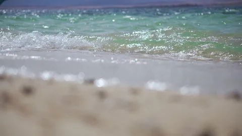 Close-up of sunny waves on Red Sea sand beach, Egypt Stock-Footage 294892553