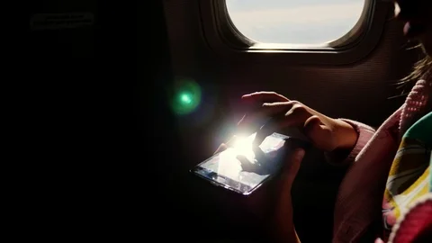 Close-up. the sun's rays are reflected in the phone. dark silhouette of kid 스톡 동영상 97200757