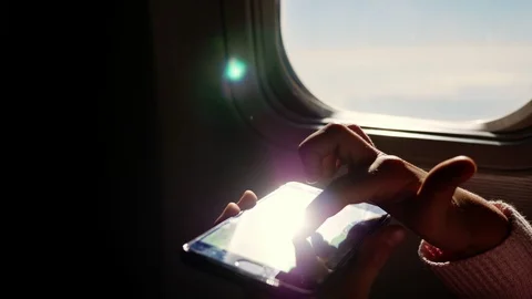 Close-up. the sun's rays are reflected in the phone. dark silhouette of kid Video stock 97200831