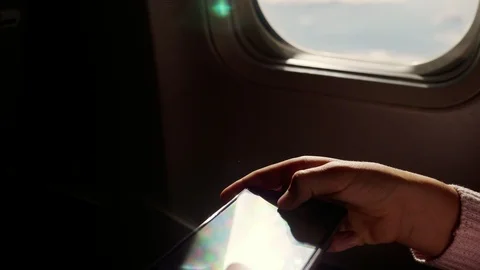 Close-up. the sun's rays are reflected in the phone. dark silhouette of kid Video stock 97200983