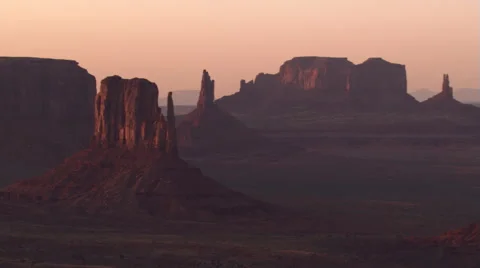 Close sunset flight past Three Sisters in Monument Valley Stock Footage 59526010