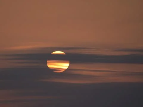 Close-Up Sunset Through Dramatic Cloud Layers - Telephoto close-up of the v.. Stock Photos