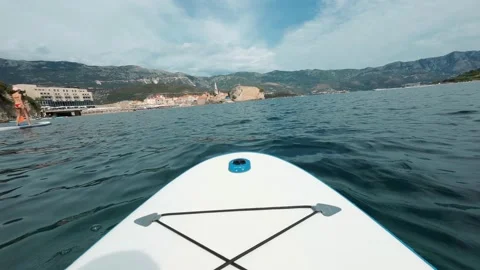 Close-up of a SUP board on the smooth water of a sea Stock Footage 221671200