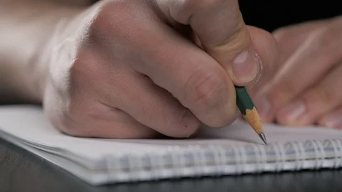 Close up super macro shot of a man hand writing something on the paper notebook Stock-Footage 87305171