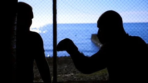 Close-up. Super slow motion. silhouettes. Two male boxer athlete are training in Stock Footage 119666868