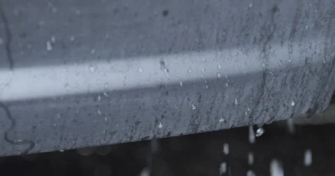 Close up super slow motion of water droplets dripping off of car Stock Footage 138861895