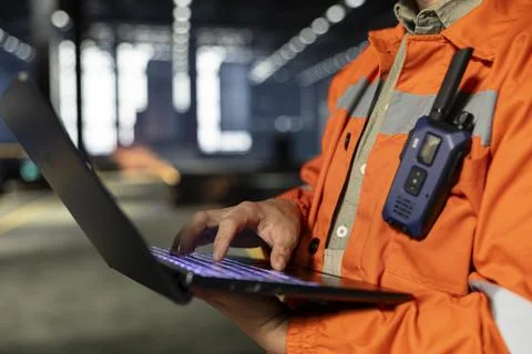 Close up of supervisor in warehouse plant using laptop to guide operator teams Stock Photos