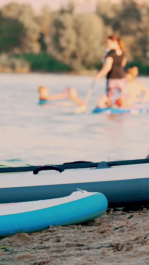 Close-up, SUPs, stand up paddle boards . they lieing on the sand of the river Video stock 322115042