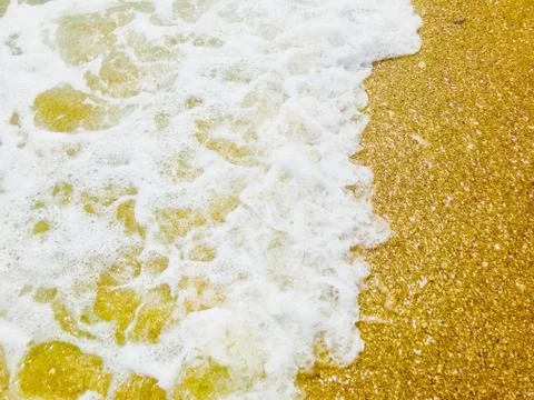 Close Up Of Surf On Sandy Beach Foto stock
