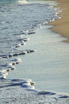 Close-up of surf on sandy beach Stock Photos