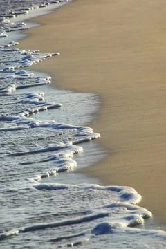 Close-up of surf on sandy beach Stock Photos