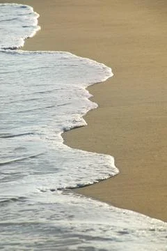 Close-up of surf on sandy beach Stock Photos