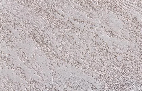 Close-up surface detail of old rough white plaster wall texture, macro. Stock Photos