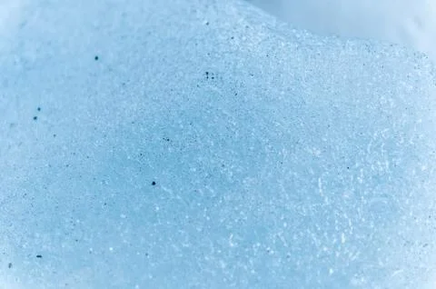 A close-up of the surface of a fragment of a glacier with a structure of strips Stock Photos