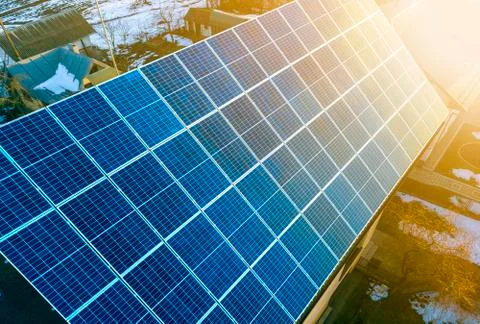 Close-up surface of lit by sun blue shiny solar photo voltaic panels system o Stock Photos