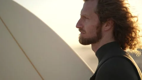 Close up of a surfer looking at the sets getting ready to go in Stock Footage 340209413