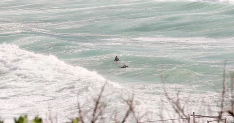 Close up of surfers in Wild stormy waves crashing on the east coast of sydne Stock Footage 137623359