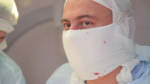 Close-up. surgeon face during surgery. in a protective, sterile mask. Stock Footage 135310082