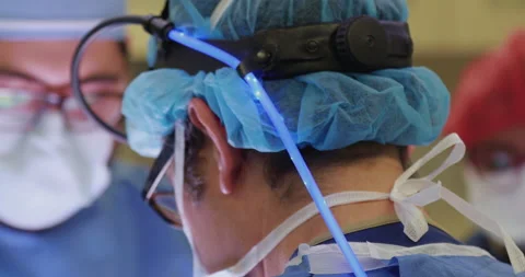 Close Up of Surgeon operating with eyeglasses and surgery head lamp Stock Footage 146640491