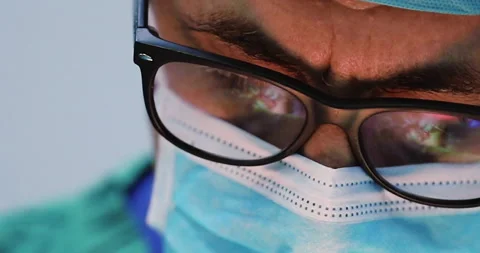 Close Up of Surgeon operating with surgery reflection in eyeglasses Stock Footage 146166183