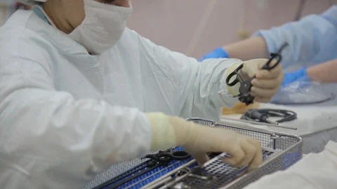 Close-up. The surgeon's assistant prepares surgical endoscopic instruments for Stock Footage 94761398