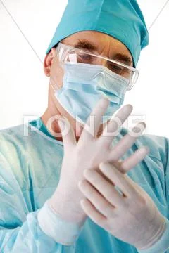 Close-up of surgeons hand wearing sterile glove over white background Stock Photos